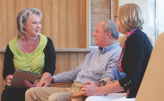 Patient navigator meeting with two patients.